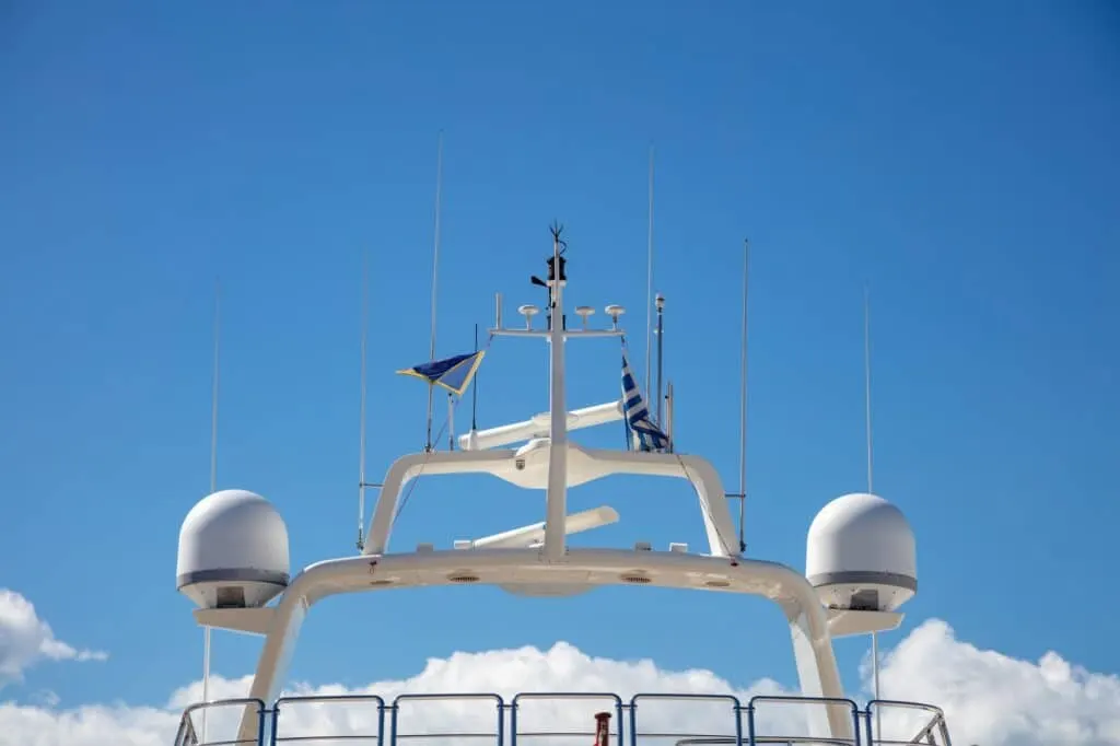 Yacht rooftop, satellite radar, antennas background marina Flisvou, Greece.
